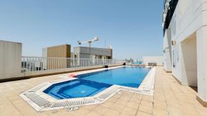 a swimming pool on the roof of a building at Ginger Luxury House in Juffair