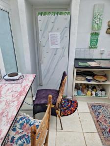 a room with a table and a chair and a counter at Shannon Estuary Glamping Budget-Sustainable-Biodiversity Habitat--Rustic-Countryside Holiday Accommodation in Effernan +57 photos