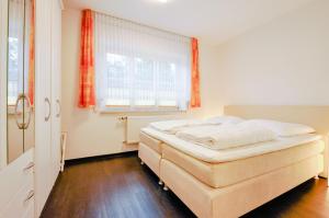 a bedroom with a bed and a window at Matzlow, Fewo Voss in Garwitz