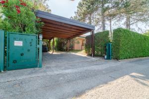 a parking lot with a green gate and a building at April in Caleri