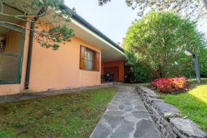 a house with a walkway in front of a yard at April in Caleri +29 photos