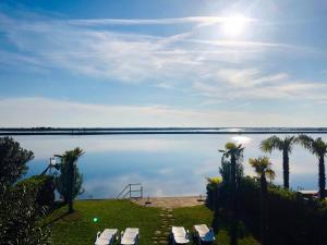 a view of a large body of water with palm trees at Tartaruga in Caleri
