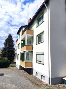 a white building with windows on the side of it at Ferienwohnung Harzoase in Bad Harzburg