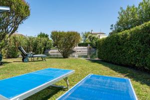 a picnic table in the grass next to a park at Margareta in Caleri +21 photos
