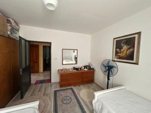 a bedroom with a bed and a dresser and a fan at Suc Valley in Klos