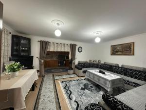 a living room with a couch and a table at Suc Valley in Klos