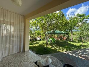 a bedroom with a view of a yard at Suc Valley in Klos
