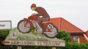 a statue of a man riding a motorcycle on a sign at Ferienhaus in Teterow