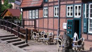 a group of tables and chairs in front of a building at Ferienhaus in Teterow