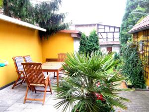 a patio with two chairs and a table and a plant at Ferienhaus in Teterow