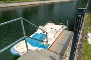 a small boat parked at a dock in the water at D Oro in Caleri +29 photos