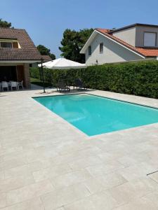 a swimming pool in front of a house at Fortuna in Palazzo Vianello