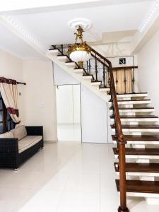 a living room with a staircase and a couch at Princess Rose Villa in Vavuniya