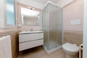 a bathroom with a shower and a toilet and a sink at LORY'S HOUSE in Porto Cesareo +40 photos
