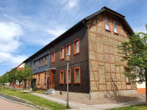 a black and brown building with orange windows at Ferienwohnung Fessel in Hasselfelde