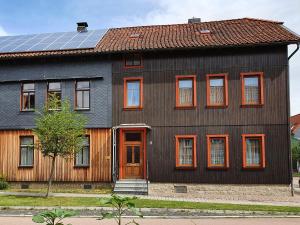 a house with a solar panel on top of it at Ferienwohnung Fessel in Hasselfelde