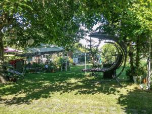 a park with a swing set under a tree at Gemütliche Ferienwohnung Löbert in Lübbenau