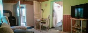 a living room with a table and a television at Gemütliche Ferienwohnung Löbert in Lübbenau +15 photos