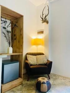 a living room with a chair and a television at Baker's cottage in Kosgoda