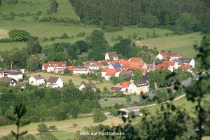 a small village in a green field with houses at Ferienwohnung Hamel in Kirchlotheim