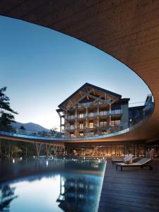 a large building with a pool in front of it at Harmony Valley Resort in Szklarska Poręba