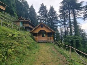 a small cabin on the side of a hill at Mid Conifer Cottage Villa in Dalhousie