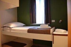 two beds in a room with green walls and a window at Holiday Home Sweet Dreams in Pučišća +45 photos