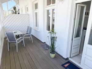 a patio with a table and chairs on a porch at Villa Minna Whg 06 mit Balkon in Göhren