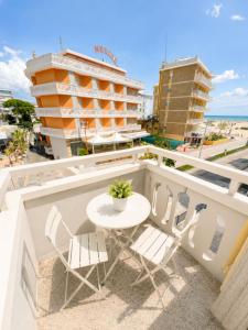 a table and chairs on a balcony with a building at RESIDENCE PACE - Agenzia Cocal in Caorle