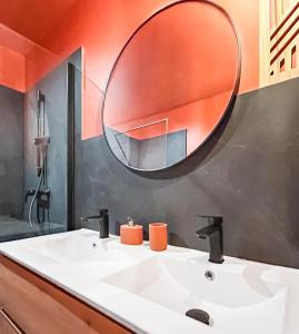 a bathroom with a white sink and a mirror at T2 lumineux, moderne, calme & central à Montargis in Montargis +19 photos
