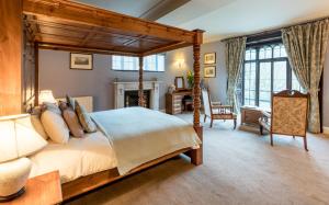 a bedroom with a canopy bed and a living room at Badger Bar in Ambleside
