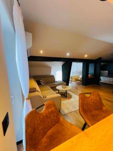 a large living room with a couch and chairs at Forest home in Konjic