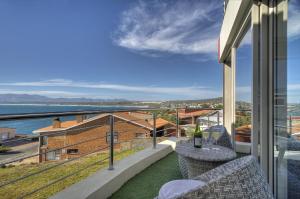 a balcony with a view of the ocean at Sea Star Lodge in Gansbaai