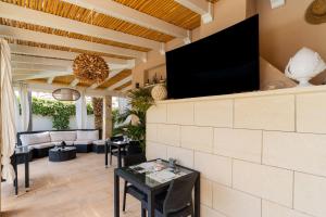 a living room with a flat screen tv on a wall at B&B Annita in Porto Cesareo