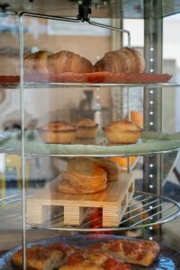 a display case with various types of pastries and bread at B&B Annita in Porto Cesareo