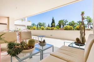 a living room with plants on a balcony at Apartamentos Guadalpin Boutique in Marbella
