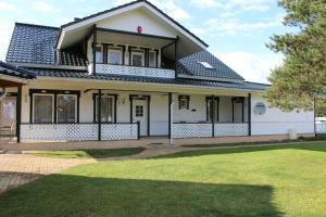 a house with a black roof at Kuru Villa in Kuru