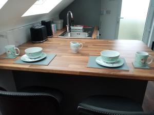 a kitchen counter with two cups and saucers on them at Radharc soiléir in Doolin +10 photos