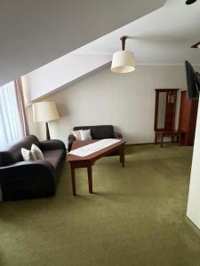 a living room with a couch and a coffee table at Hotel Neo Międzyrzecz in Międzyrzecz