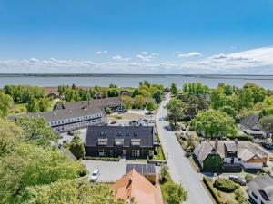 an aerial view of a town with houses and a lake at Ferienwohnung To Huus in Born