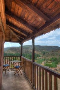 a porch with a table and chairs and a view at La Posada De Santa Ana in Tramacastilla