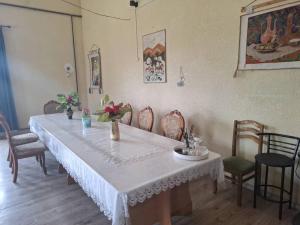 a dining room table with a white tablecloth and chairs at Мотель Эмир in Pokrovka