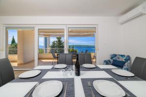 a dining room with a table and a view of the ocean at Melanie in Crikvenica