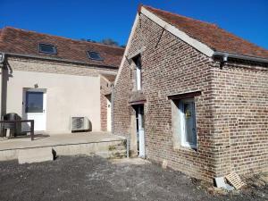 a brick building with a patio in front of it at Jauxvial 2 in Jaux