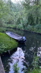 a boat sitting in the middle of a river at Ferienwohnung Verena Wunderlich in Schlepzig +18 photos