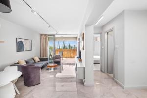 a living room with a couch and a table at Latitudes 1 Bedroom Apartment in Meneou