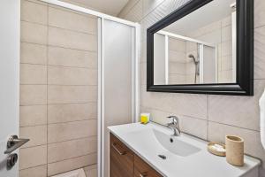 a bathroom with a sink and a mirror at Latitudes 1 Bedroom Apartment in Meneou +11 photos