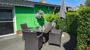 a table with chairs and an umbrella on a patio at Ferienwohnung "Christina" in Steinkirchen