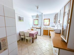 a kitchen and dining room with a table and chairs at Glamping & Camping Green Istria in Marezige
