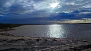 a large body of water with a cloudy sky at Holzhaus am Bergheider See in Buschmühle +31 photos